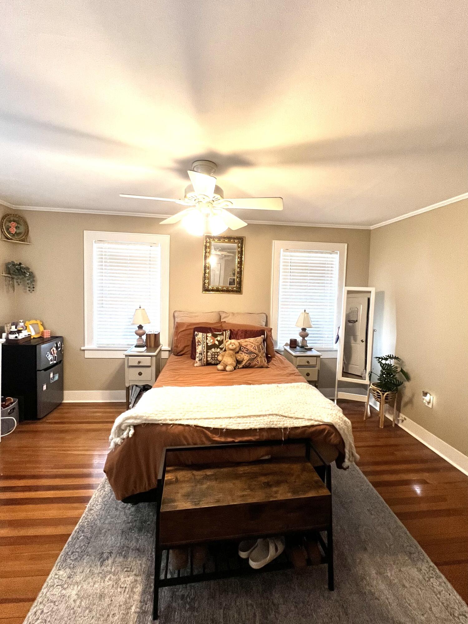 2315 16th Street Lubbock, TX 79401 - Photo 4 of 20 a bedroom with a bed a mirror and lamp