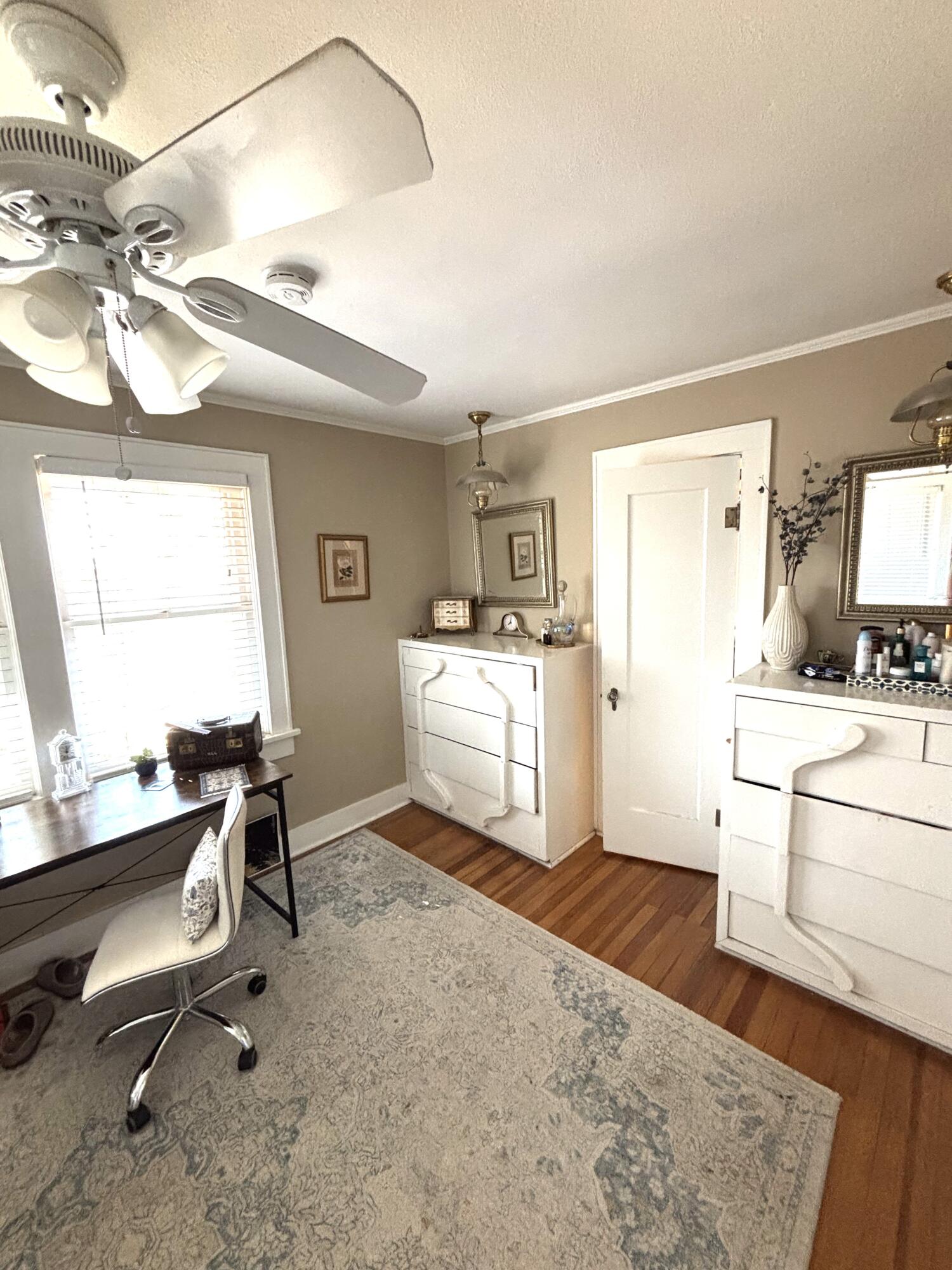 2315 16th Street Lubbock, TX 79401 - Photo 7 of 20 a room with a chair and white cabinets