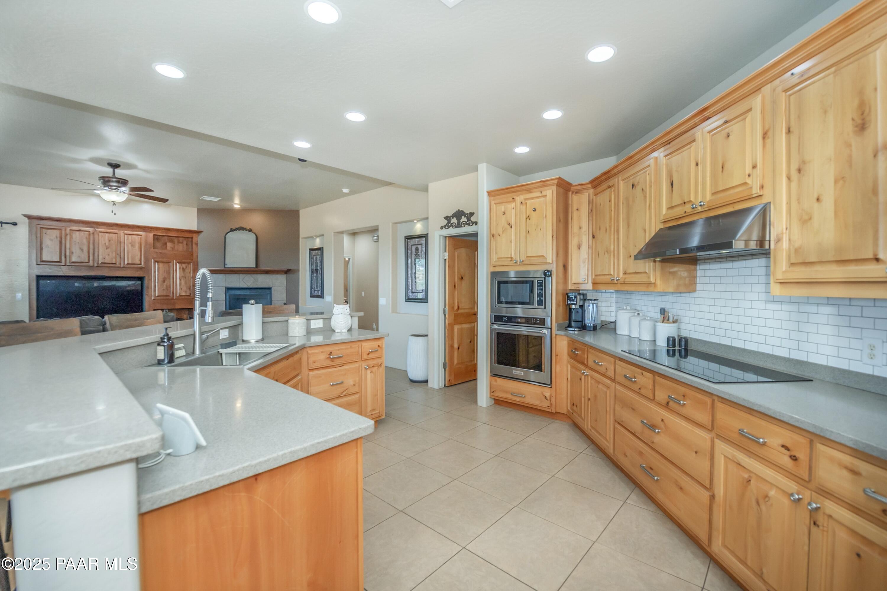 171 Enchanted Road Dewey, AZ 86327 - Photo 11 of 62 a large kitchen with stainless steel appliances granite countertop a sink and cabinets