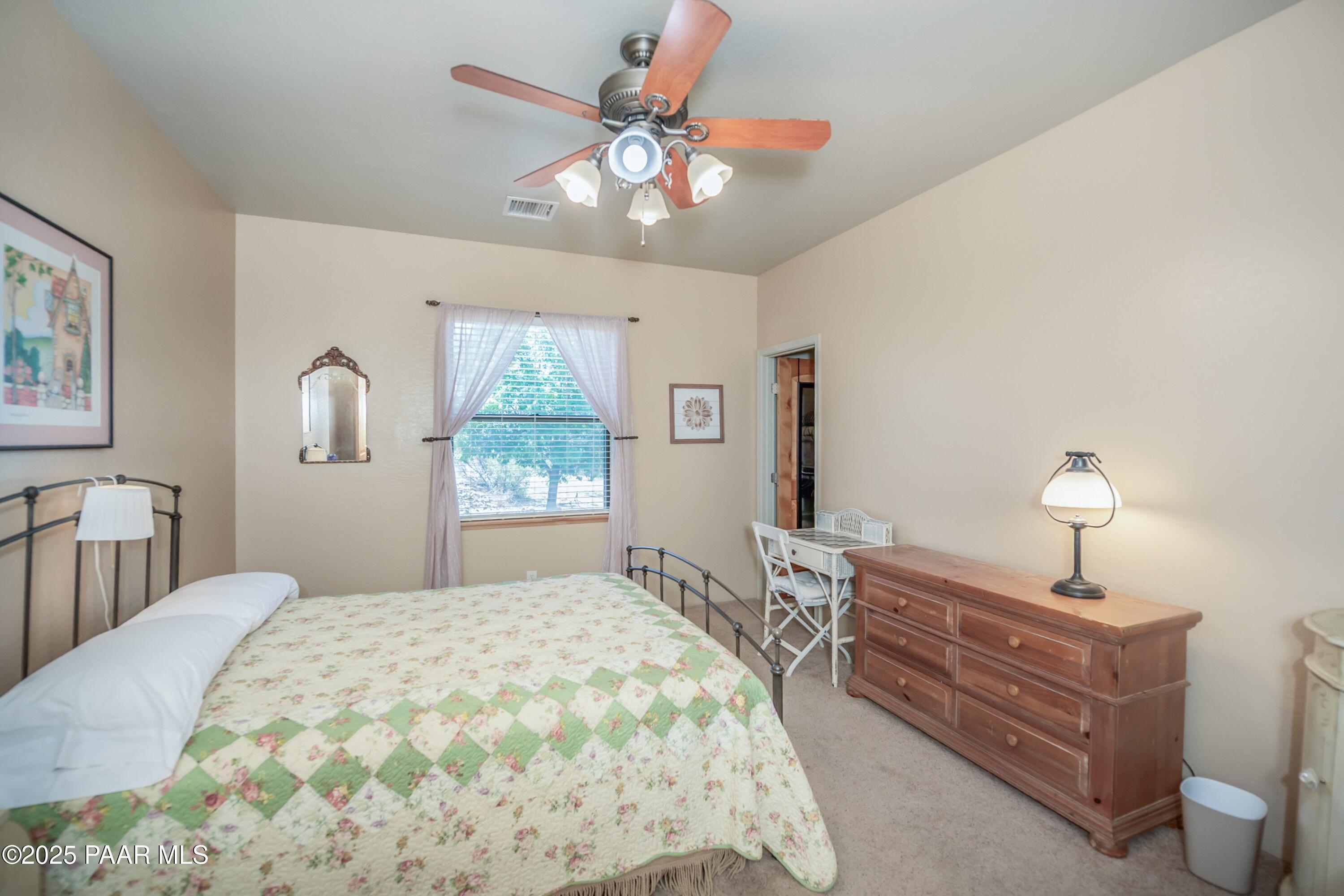 171 Enchanted Road Dewey, AZ 86327 - Photo 22 of 62 a bedroom with a bed and a chandelier