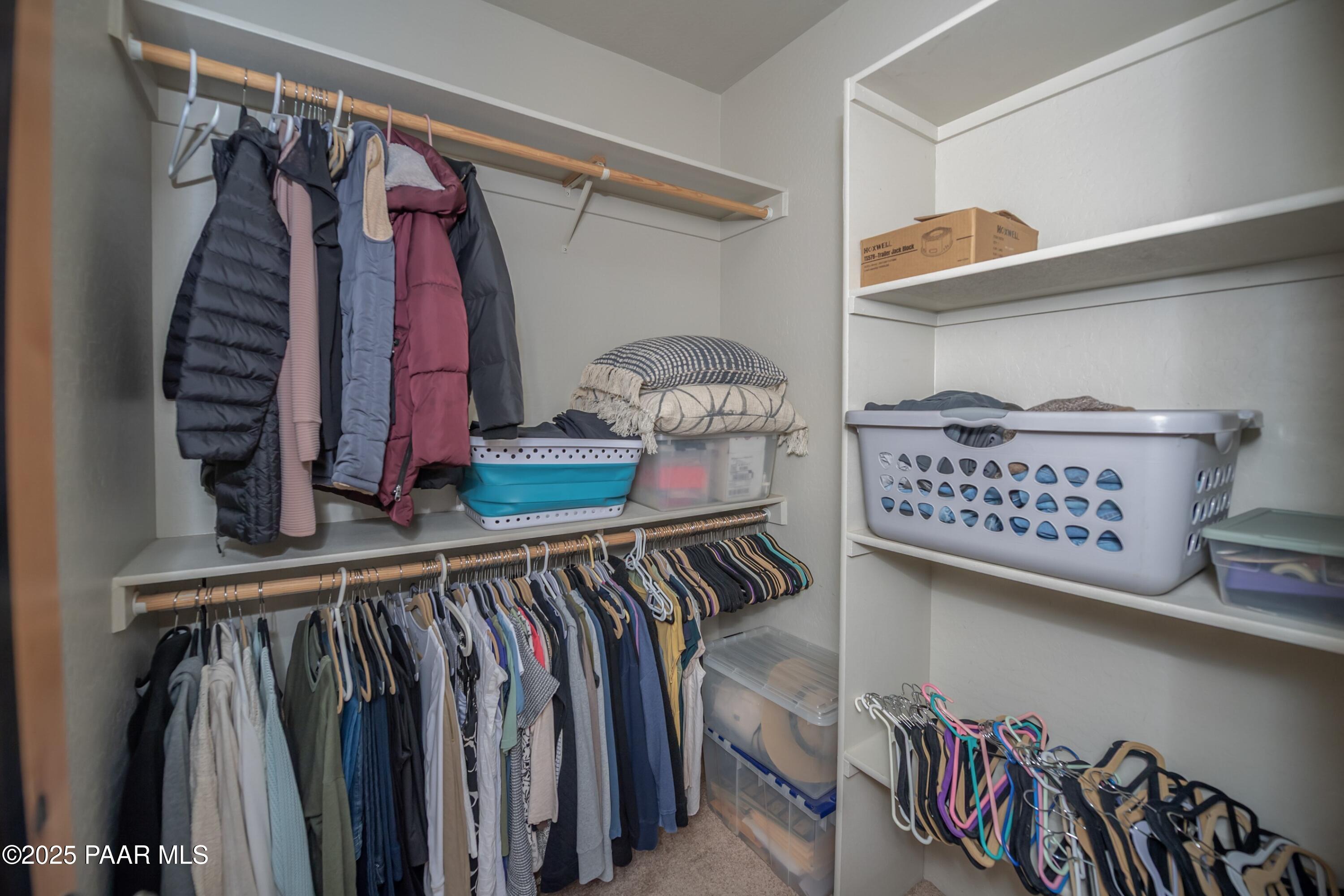 171 Enchanted Road Dewey, AZ 86327 - Photo 23 of 62 a view of walk in closet with clothes and shoes