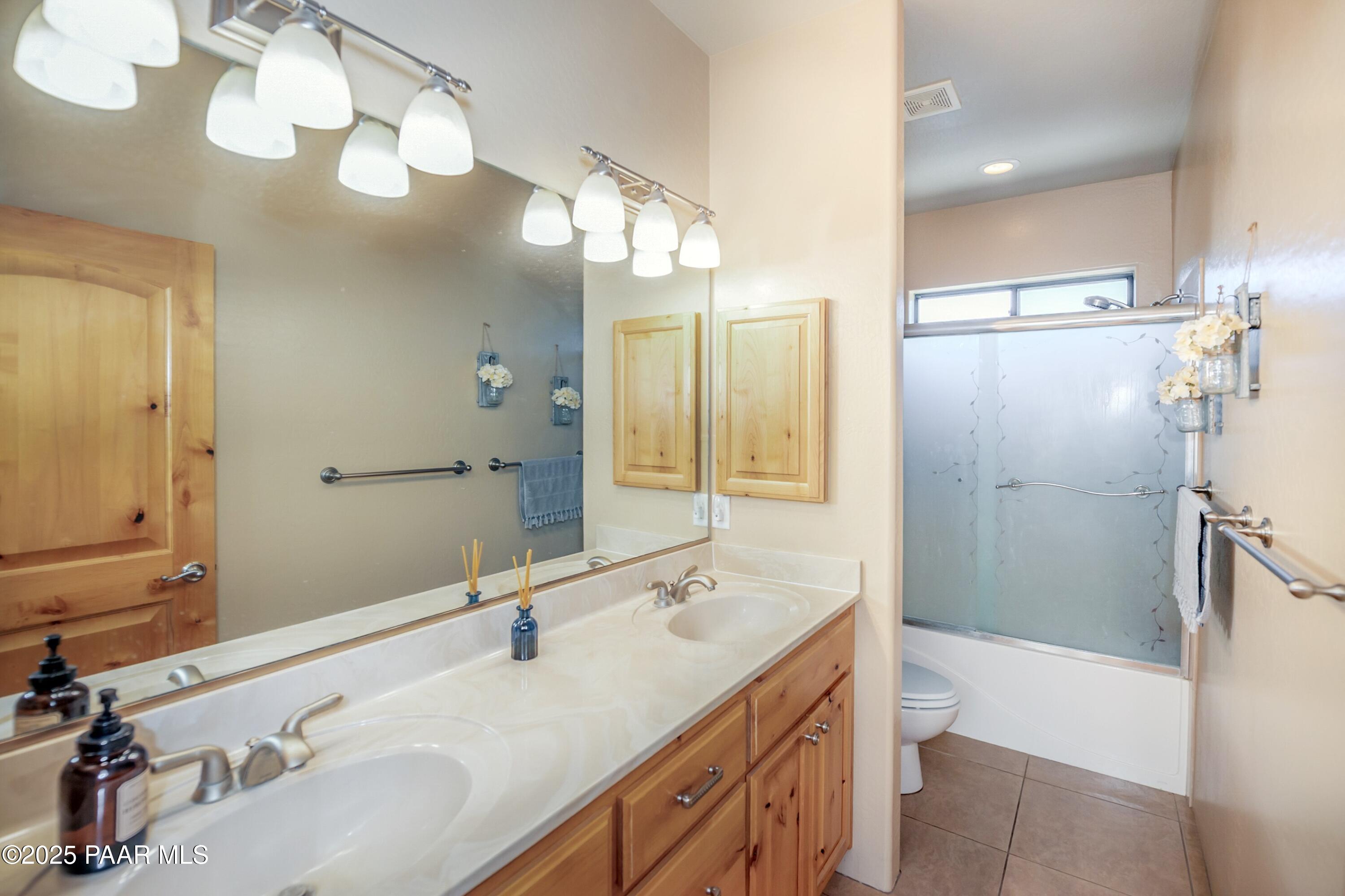 171 Enchanted Road Dewey, AZ 86327 - Photo 24 of 62 a bathroom with a double vanity sink mirror double and shower