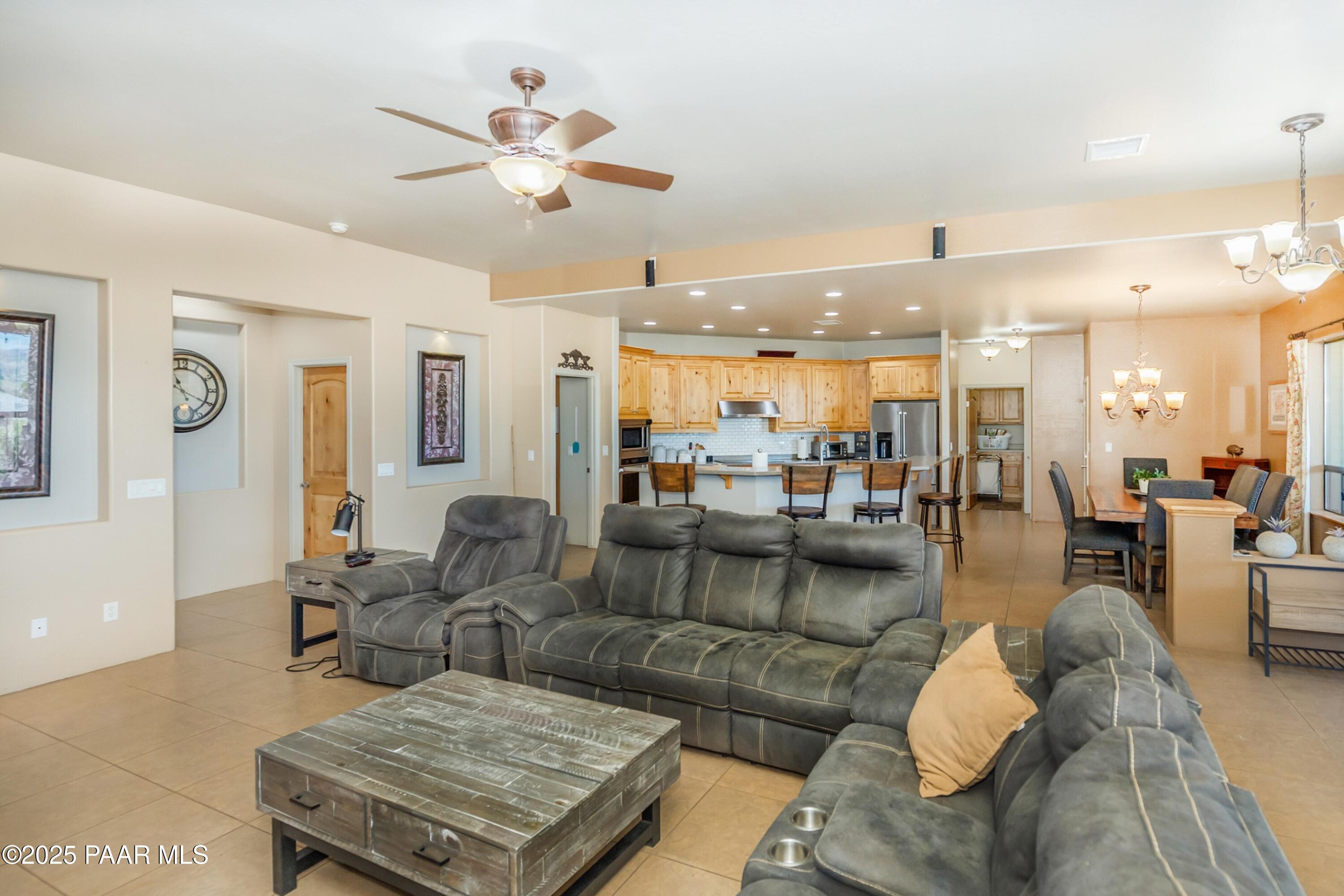 171 Enchanted Road Dewey, AZ 86327 - Photo 5 of 62 a living room with furniture kitchen view and a chandelier