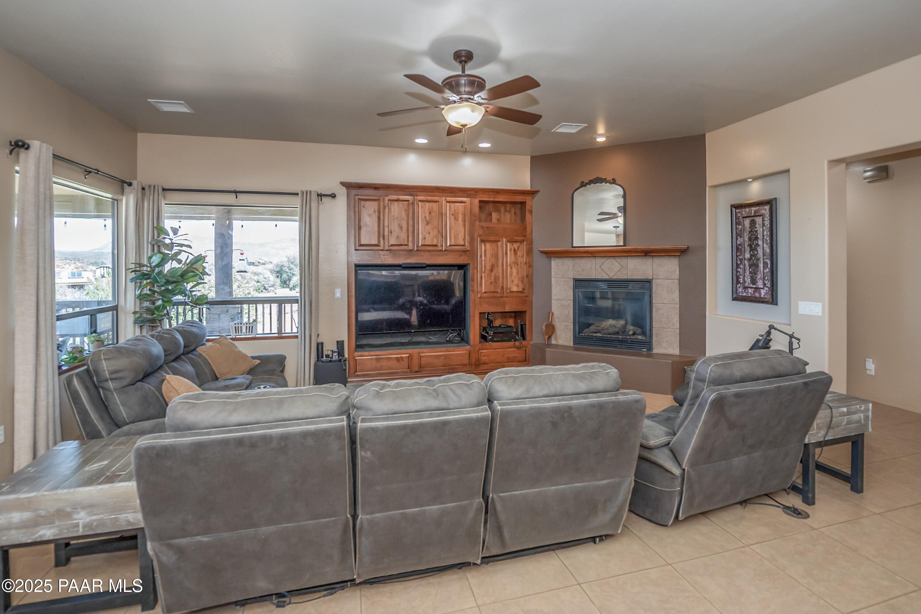 171 Enchanted Road Dewey, AZ 86327 - Photo 6 of 62 a living room with furniture a fireplace and a large window