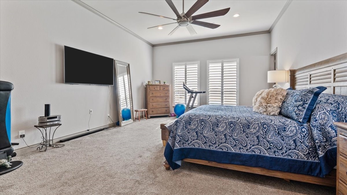 27785 Log Cabin Road Montgomery, TX 77356 - Photo 29 of 50 a spacious bedroom with a bed and a flat screen tv