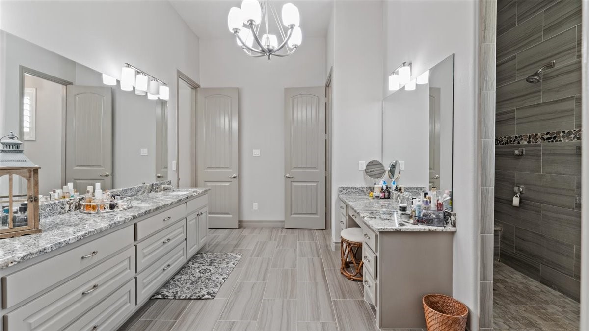 27785 Log Cabin Road Montgomery, TX 77356 - Photo 32 of 50 a spacious bathroom with double vanity sinks a mirror and a shower