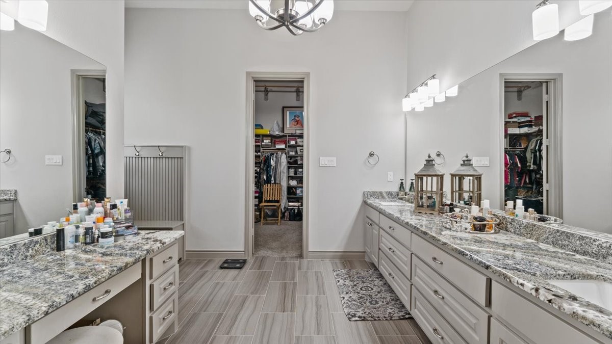 27785 Log Cabin Road Montgomery, TX 77356 - Photo 33 of 50 a spacious bathroom with a granite countertop sink a mirror and shower