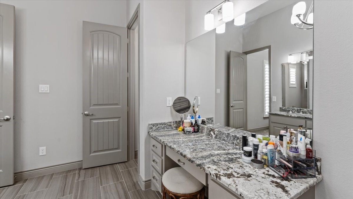 27785 Log Cabin Road Montgomery, TX 77356 - Photo 35 of 50 a bathroom with a granite countertop sink a vanity and a mirror