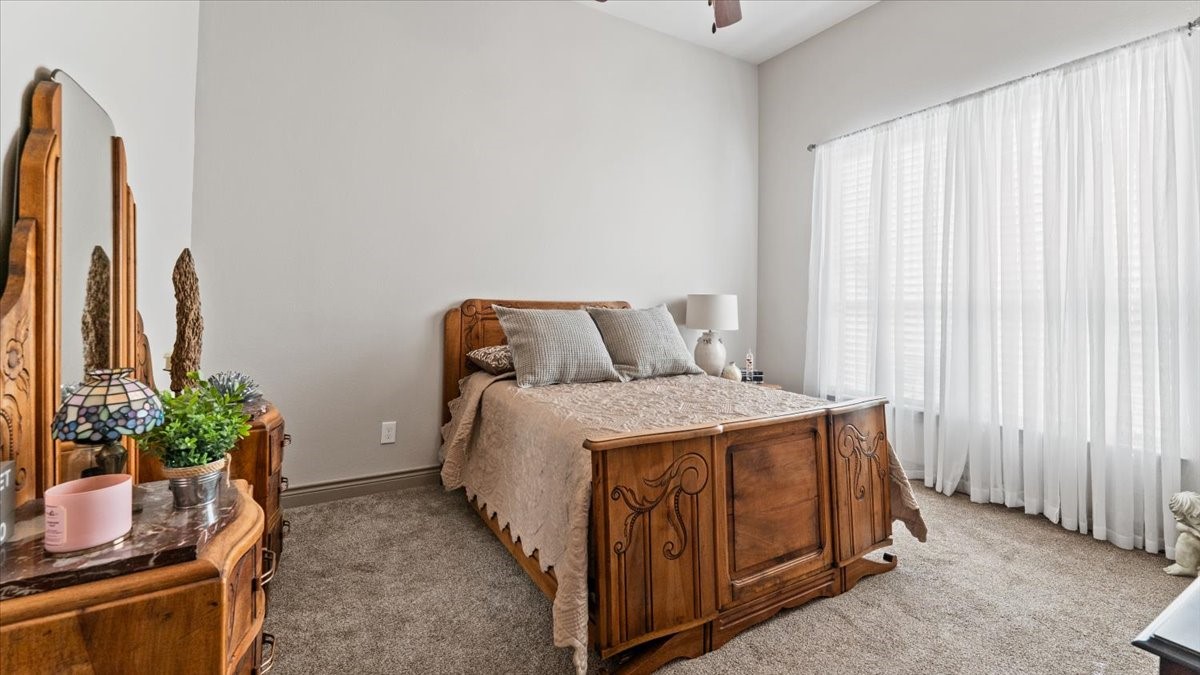 27785 Log Cabin Road Montgomery, TX 77356 - Photo 40 of 50 a bedroom with a bed and a potted plant