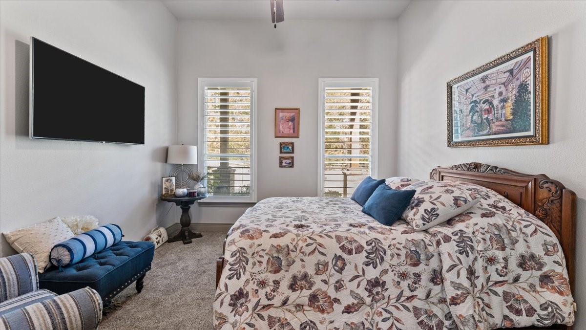 27785 Log Cabin Road Montgomery, TX 77356 - Photo 41 of 50 a bedroom with a large bed and a flat screen tv