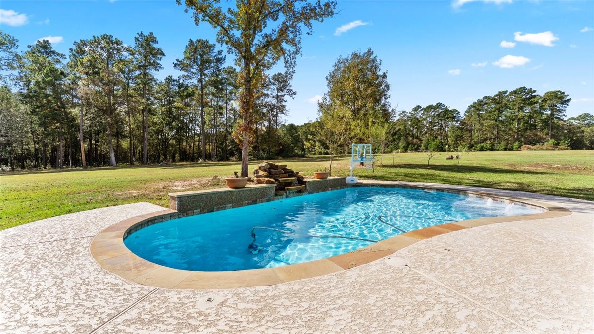 27785 Log Cabin Road Montgomery, TX 77356 - Photo 47 of 50 a view of a swimming pool with a yard
