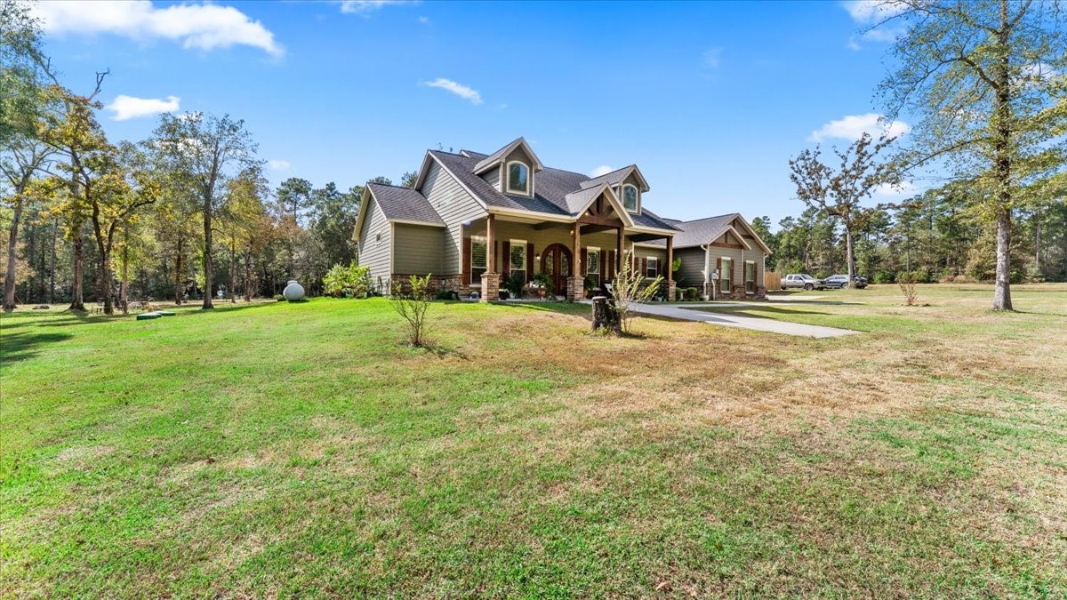 27785 Log Cabin Road Montgomery, TX 77356 - Photo 6 of 50 a front view of a house with a yard and garage