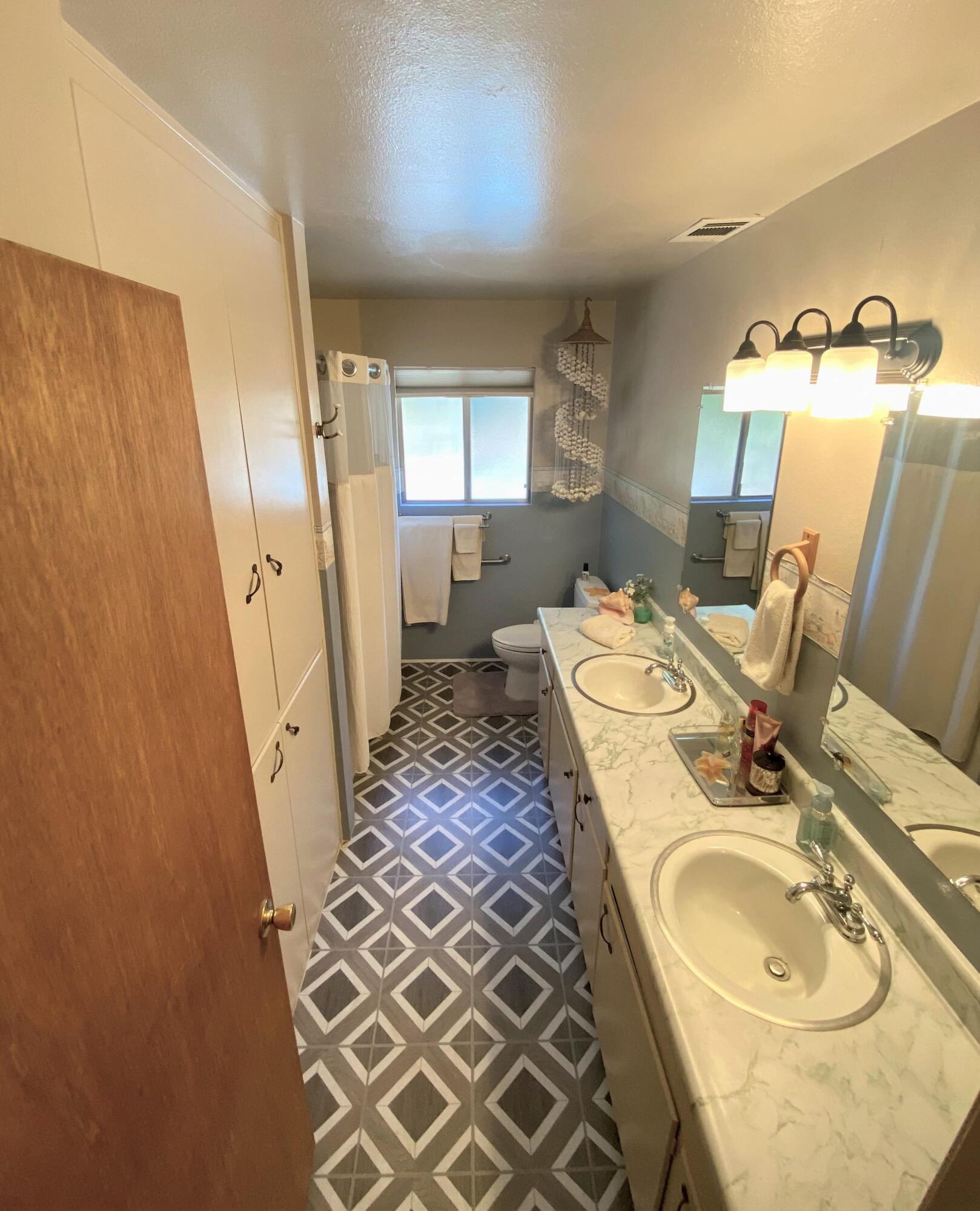40968 Grouse Drive Three Rivers, CA 93271 - Photo 14 of 31 a bathroom with a double vanity sink and mirror