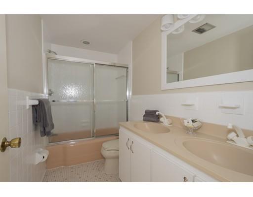 8 Saddle Club Road Lexington, MA 02420 - Photo 22 of 30 a bathroom with a sink toilet a mirror and shower