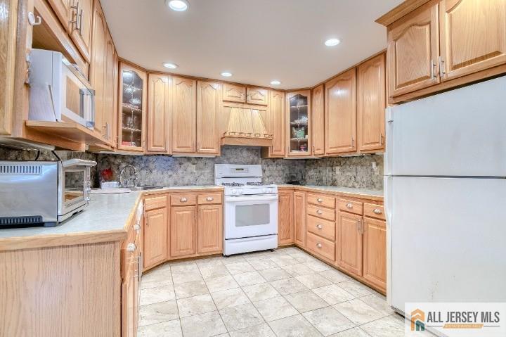 16 Pendleton Place Old Bridge, NJ 08857 - Photo 8 of 30 a kitchen with stainless steel appliances granite countertop a stove a sink and a refrigerator