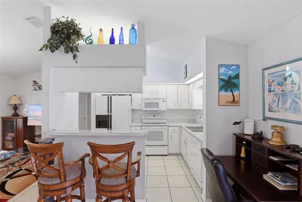 a kitchen with stainless steel appliances kitchen island granite countertop a sink and cabinets