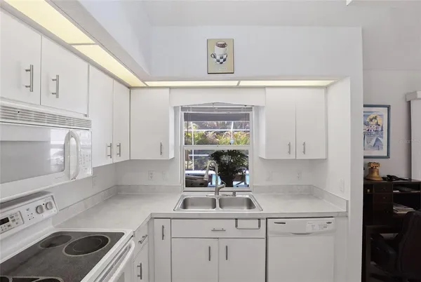 a kitchen with a sink stove and cabinets