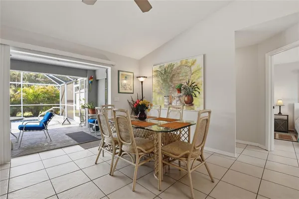 a dining room with furniture and large windows