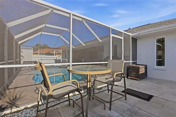 a patio with table and chairs