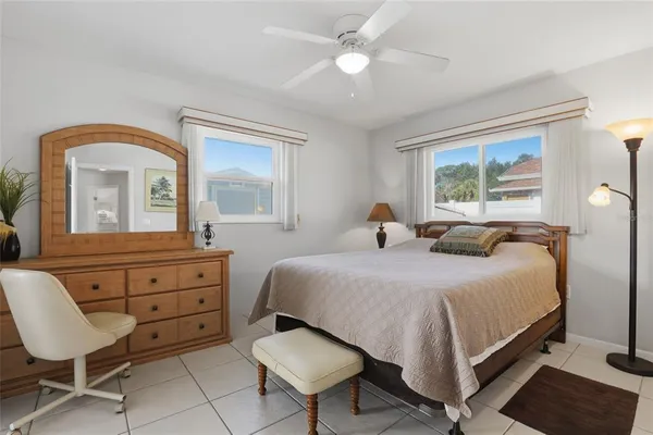 a bedroom with a bed and a dresser with mirror