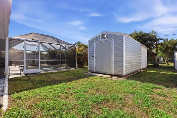 a view of a backyard with a garden and deck