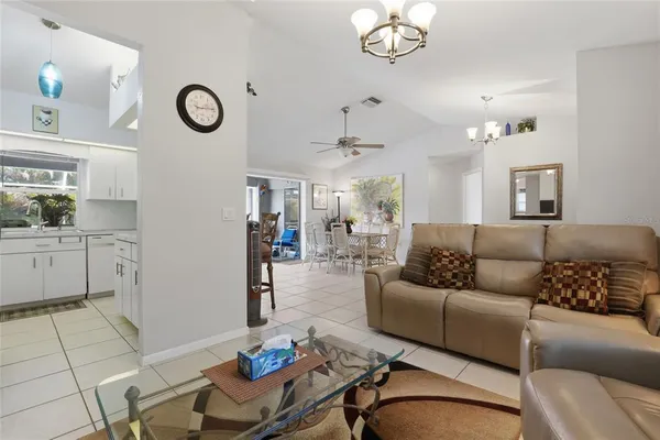 a living room with furniture a rug and a clock