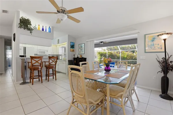 a dining room with furniture a chandelier and window