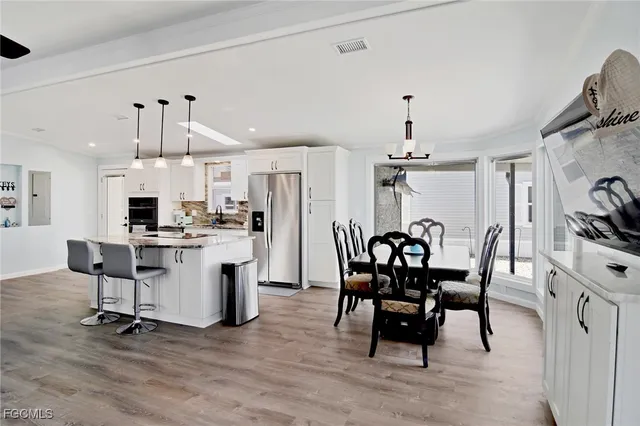 a view of a dining room with furniture and chandelier