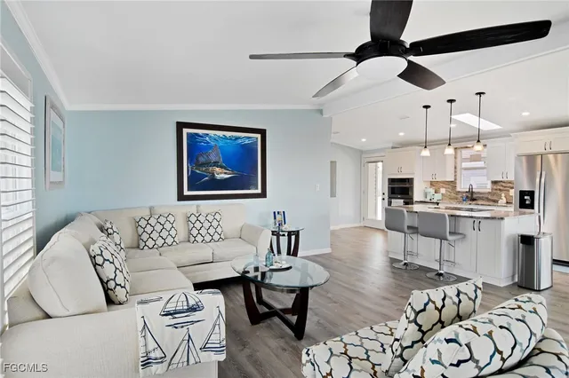 a living room with furniture and kitchen view
