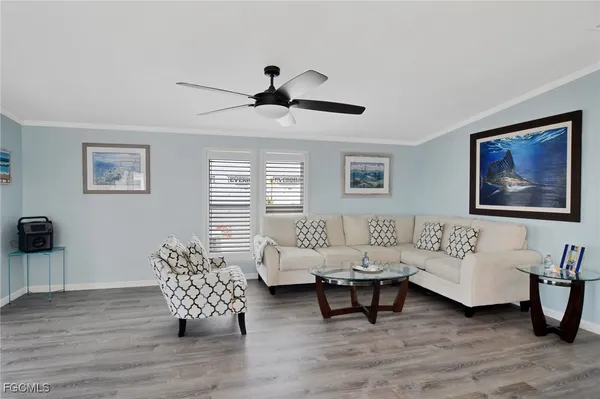 a living room with furniture a rug and a window