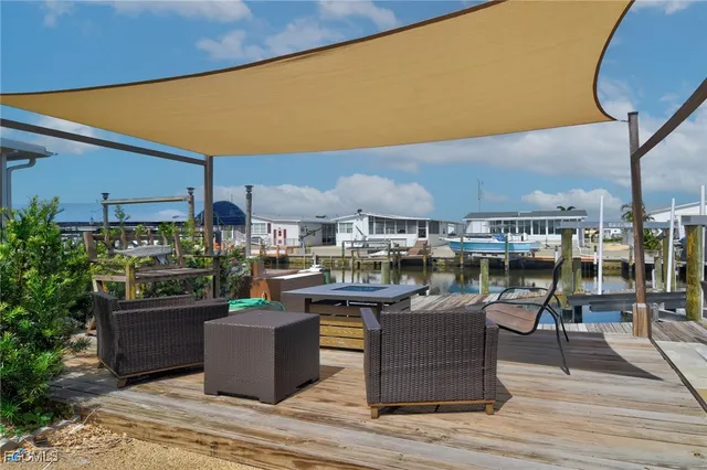 a view of a patio with dining table and chairs