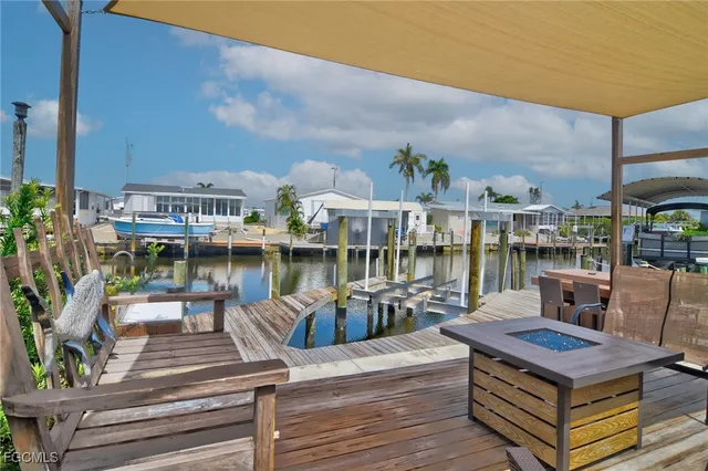 a view of a rooftop deck with couch and chairs