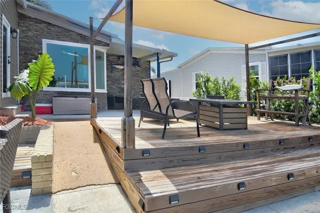 a swimming pool with outdoor seating and plants