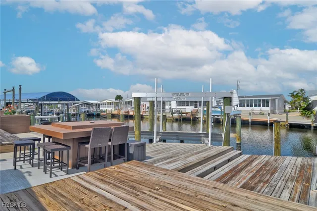 a view of a rooftop deck patio and lake view