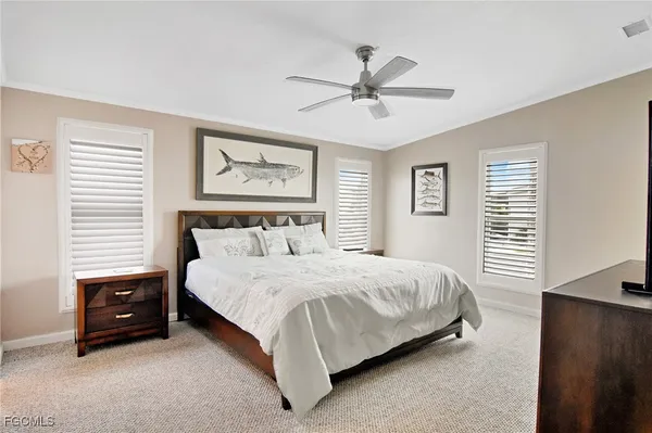 a spacious bedroom with a bed and a chandelier