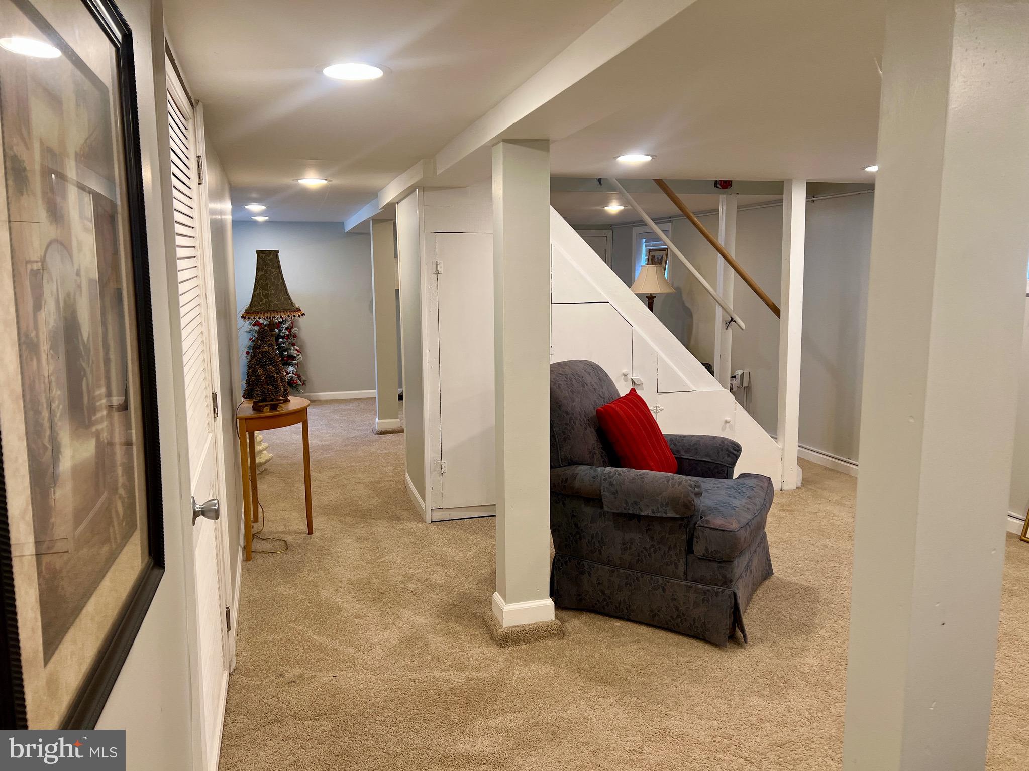 87 Saybrook Avenue Hamilton, NJ 08619 - Photo 27 of 41 a living room with furniture and a hallway