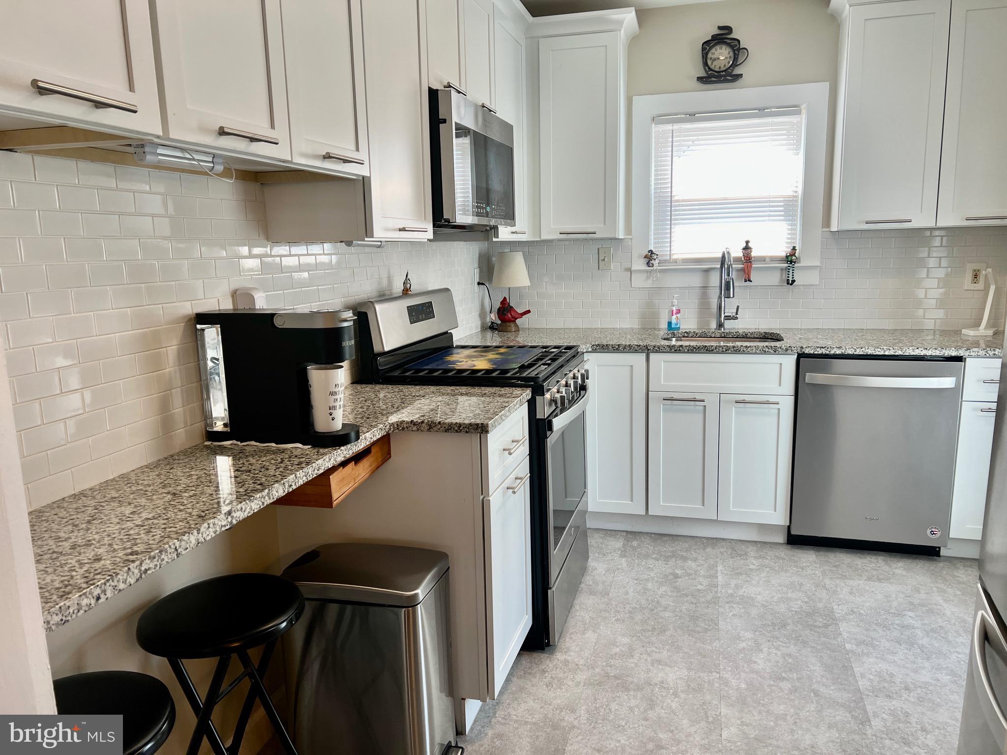 87 Saybrook Avenue Hamilton, NJ 08619 - Photo 4 of 41 a kitchen with stainless steel appliances granite countertop a sink stove and refrigerator
