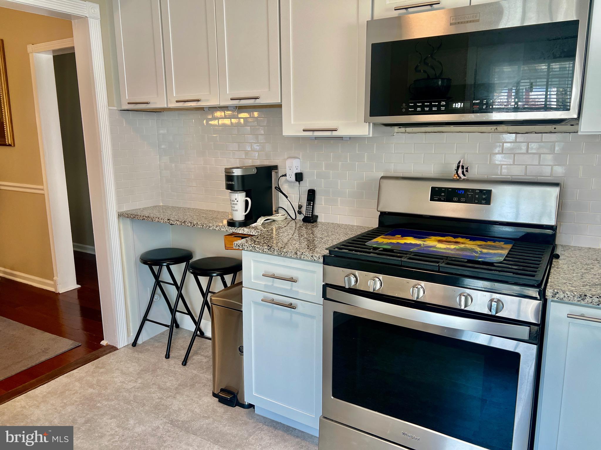 87 Saybrook Avenue Hamilton, NJ 08619 - Photo 5 of 41 a kitchen with stainless steel appliances a stove a microwave a sink and cabinets