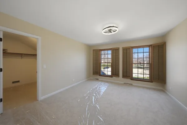 a bathroom with a bathtub a double vanity sink and mirror