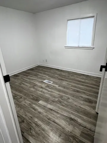a view of a room with wooden floor