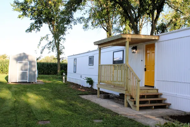 a small house with a small yard and trees