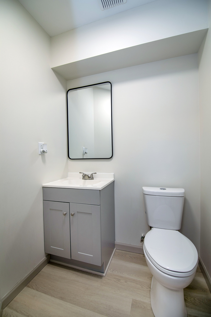 1320 South 3rd Avenue Kankakee, IL 60901 - Photo 11 of 19 a bathroom with a toilet sink and mirror
