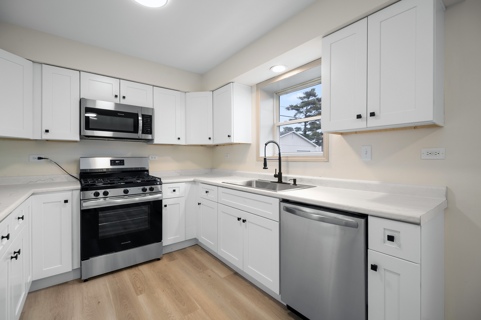 1320 South 3rd Avenue Kankakee, IL 60901 - Photo 8 of 19 a kitchen with granite countertop white cabinets and stainless steel appliances