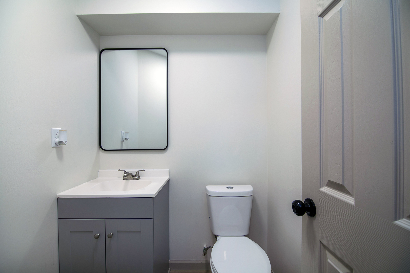 1320 South 3rd Avenue Kankakee, IL 60901 - Photo 10 of 19 a bathroom with a toilet sink and mirror