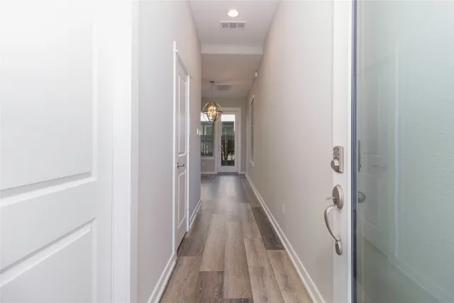 a view of a hallway with wooden floor