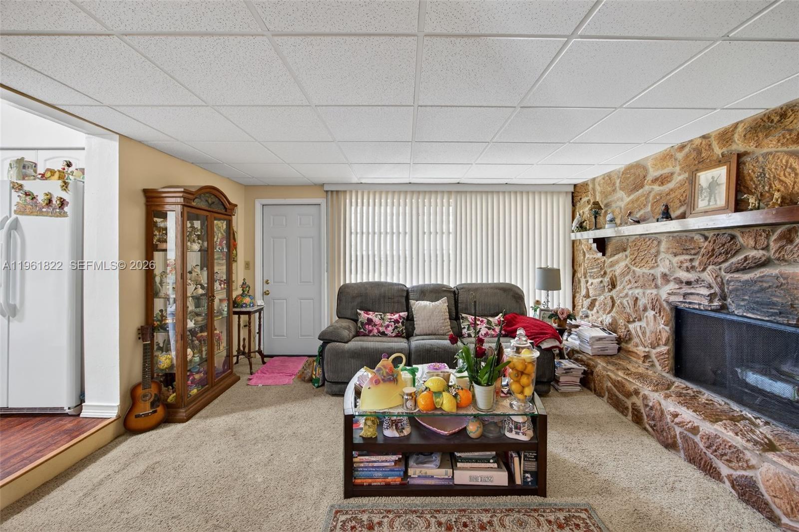 9401 Southwest 97th Avenue Miami, FL 33176 - Photo 13 of 77 a living room with furniture a fireplace and a flat screen tv