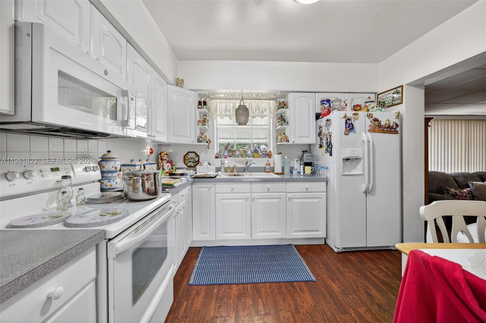 9401 Southwest 97th Avenue Miami, FL 33176 - Photo 16 of 77 a kitchen with white cabinets and white appliances