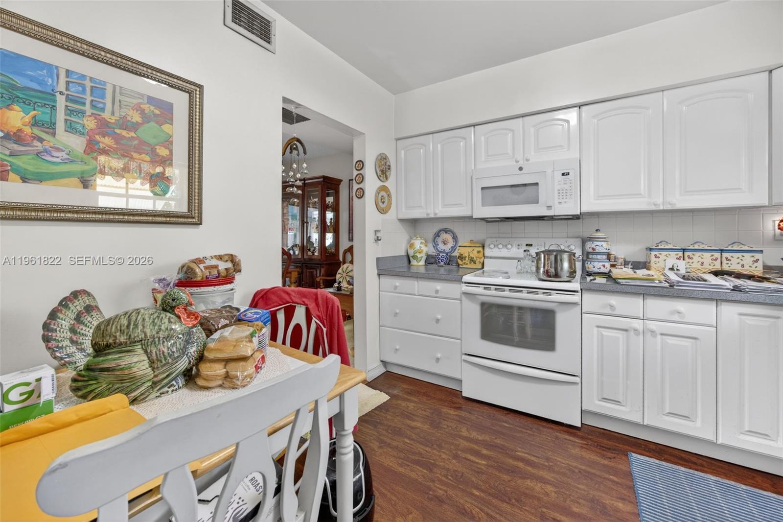 9401 Southwest 97th Avenue Miami, FL 33176 - Photo 17 of 77 a kitchen that has a lot of cabinets a sink and a stove in it
