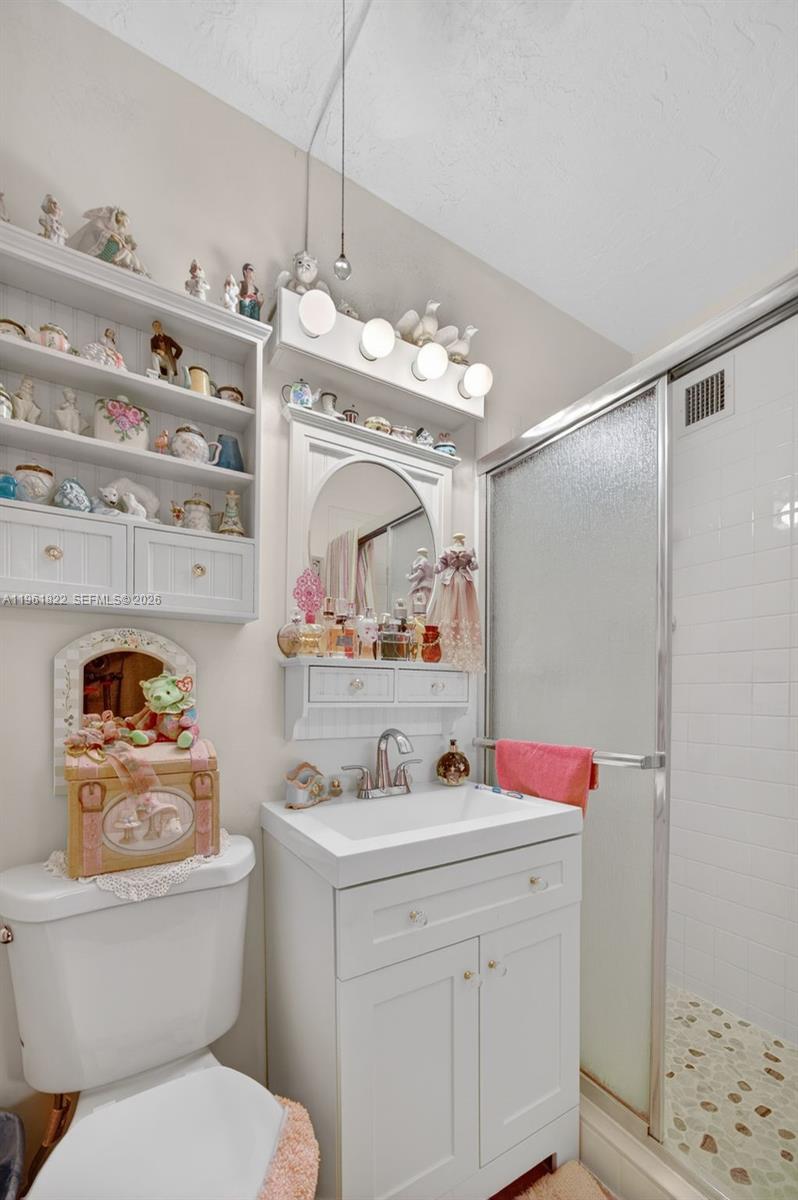 9401 Southwest 97th Avenue Miami, FL 33176 - Photo 25 of 77 a bathroom with a sink vanity mirror and toilet