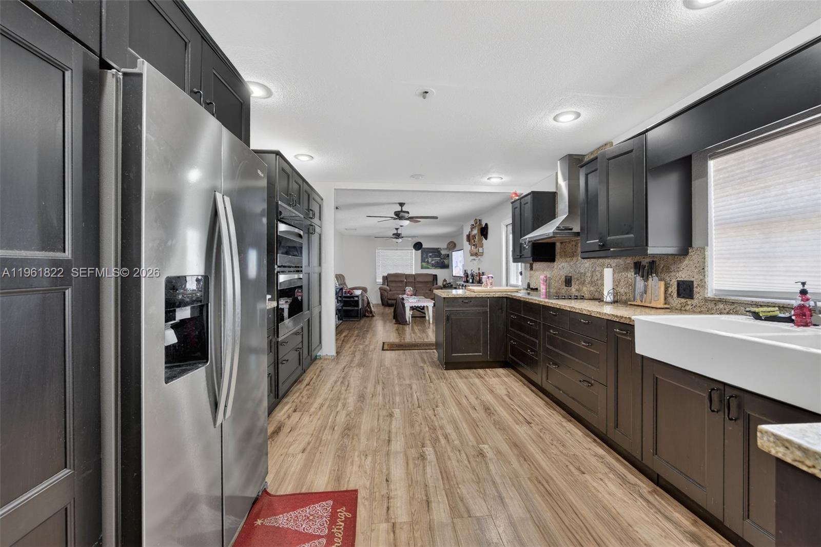 9401 Southwest 97th Avenue Miami, FL 33176 - Photo 44 of 77 a kitchen with stainless steel appliances kitchen island granite countertop a refrigerator and a sink
